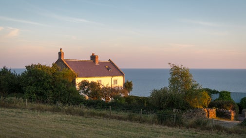 Labour in Vain Cottage (on the left) before refurbishment and Chesil Cottage (on the right) at sunset, Dorset